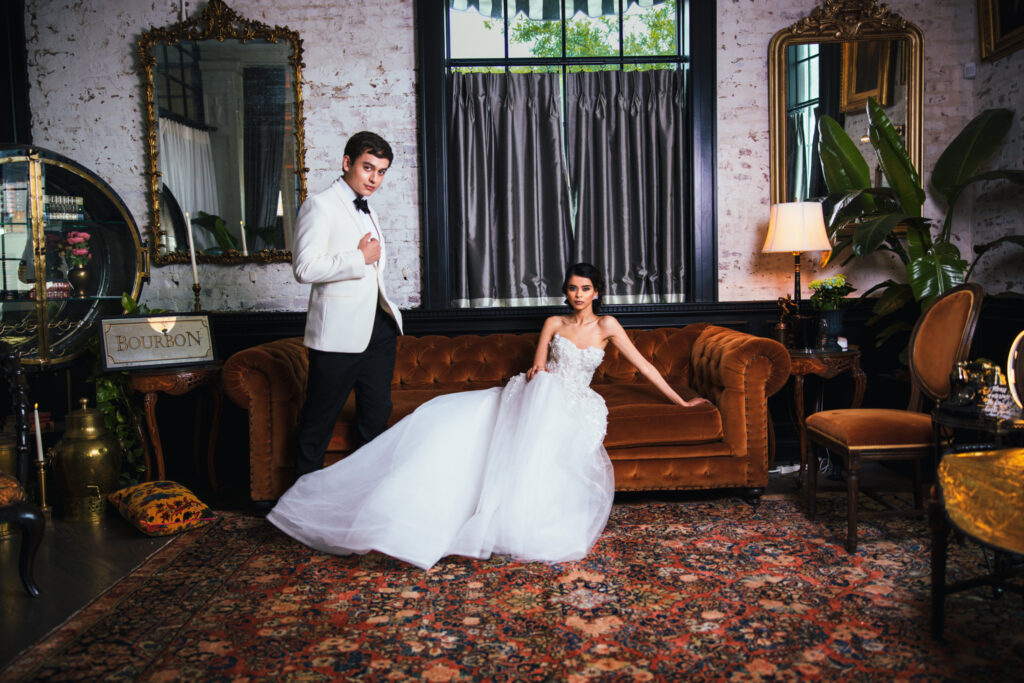 Wedding Photographer taking photo of couple on couch
